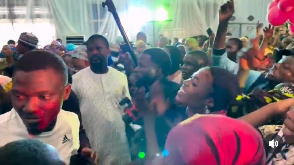 Fans React to Umar M Shareef's Surprise Show in Kano Fans recording Umar on stage with flashlight waving crowd
