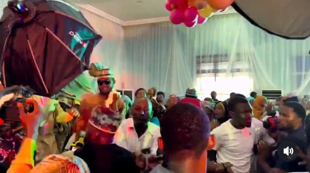 Fans React to Umar M Shareef's Surprise Show in Kano Photo of the crowd from the back with stage lights in the distance