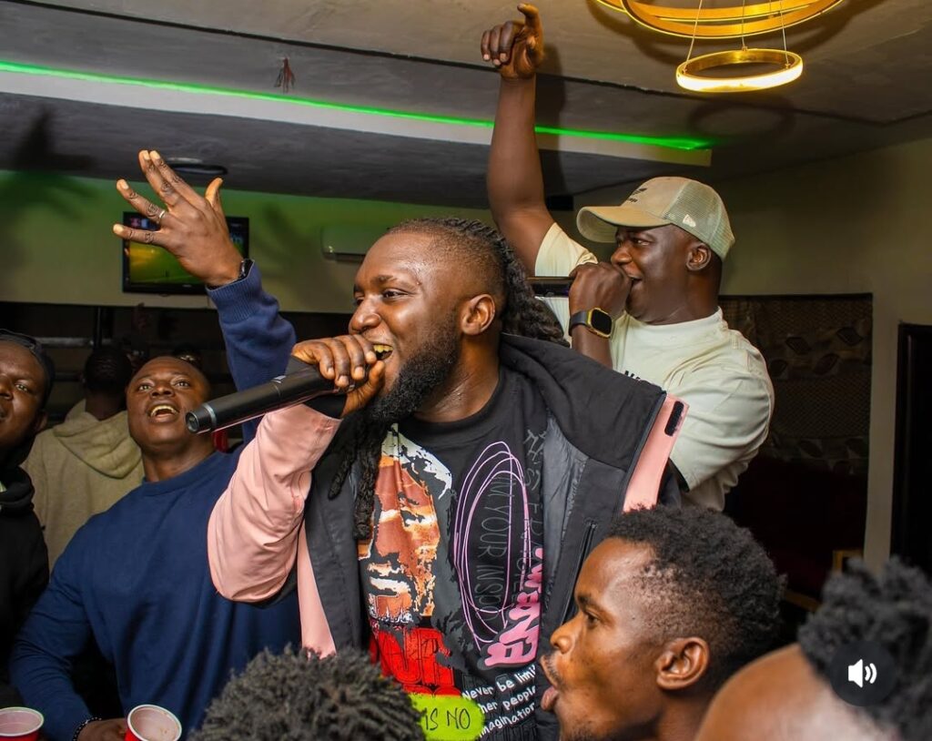 Image of Boc madaki performing his song on stage